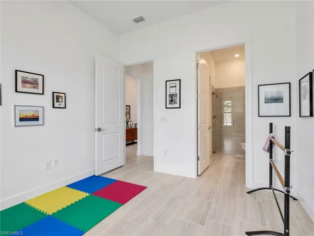 2nd Bedroom En-Site with light toned tile flooring throughout