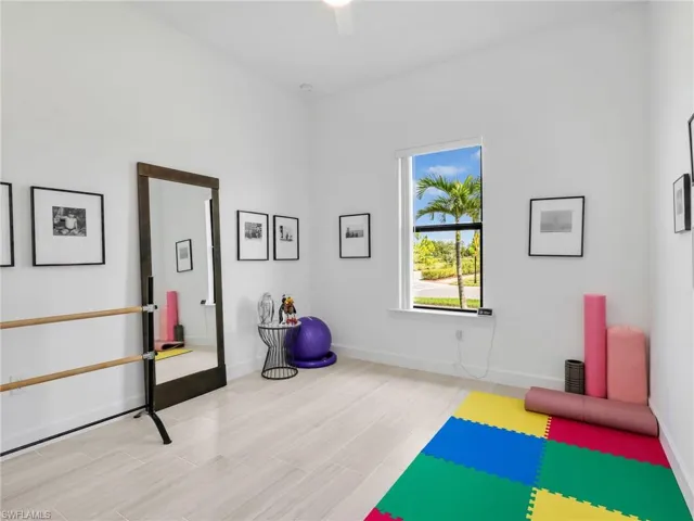 2nd Bedroom En-Suite with Light-toned tile flooring, large window with natural light, high ceilings, ceiling fan, and white wall finishes