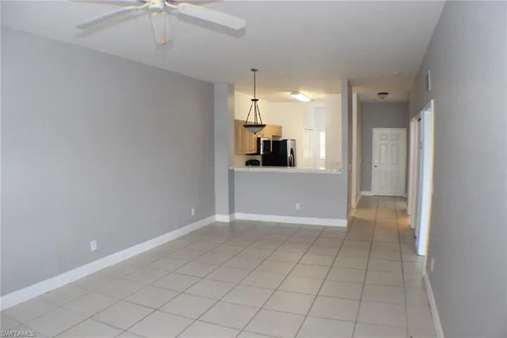 Spare room featuring light tile patterned floors and a ceiling fan