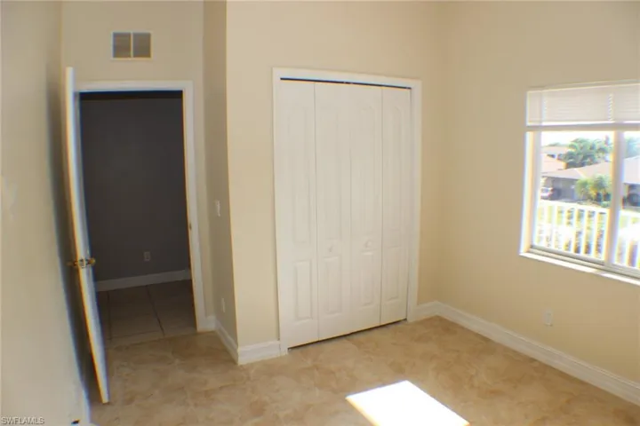 Unfurnished bedroom featuring a closet and light tile patterned floors