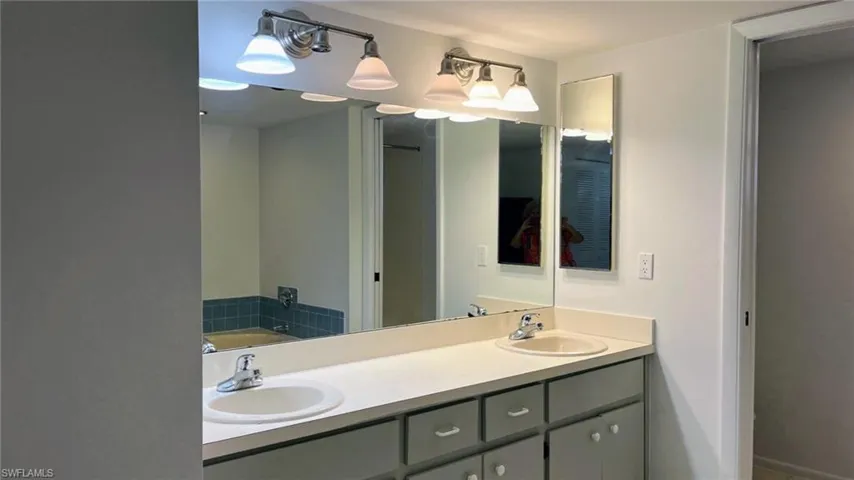 Bathroom featuring a bath and double sink vanity