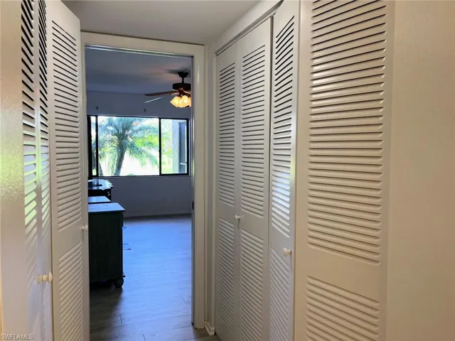 Corridor featuring dark wood-type flooring