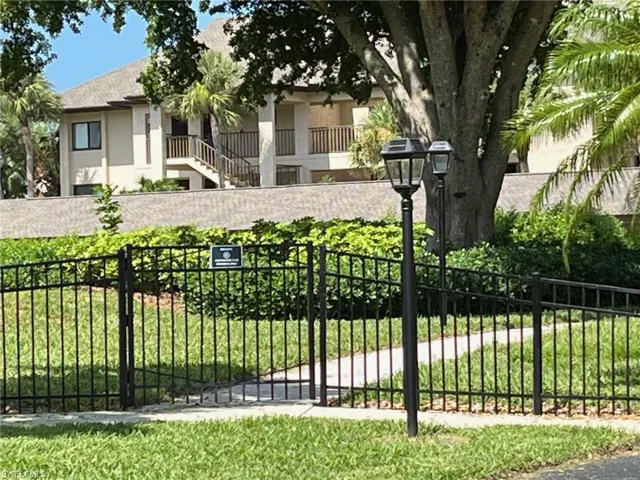 View of gate featuring a lawn
