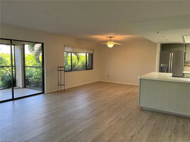 Spare room featuring light wood-type flooring and ceiling fan