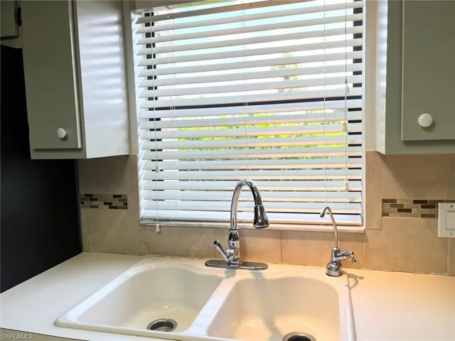 Room details with green cabinetry and sink