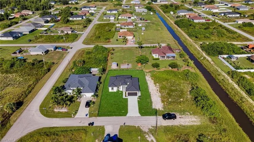 Aerial view of property's location featuring a large body of water and nearby suburban area