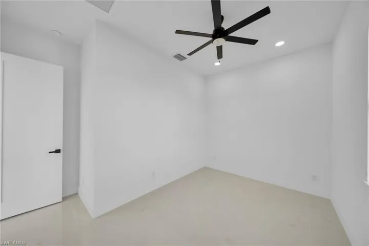 Spare room with a ceiling fan, recessed lighting, and light tile patterned flooring