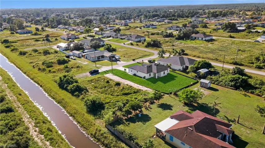 Aerial perspective of suburban area featuring a large body of water