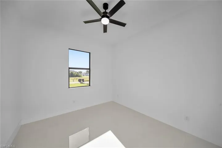 Spare room with baseboards and ceiling fan