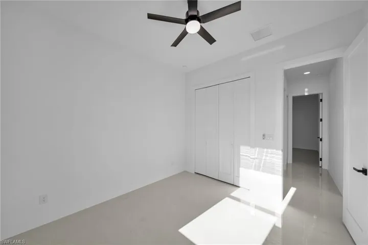 Unfurnished bedroom featuring a closet and a ceiling fan
