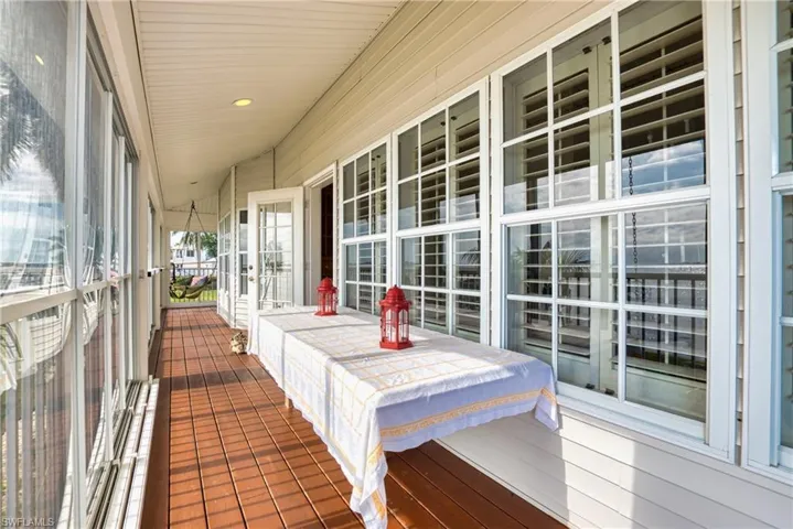 Sunroom / solarium featuring recessed lighting and wood walls