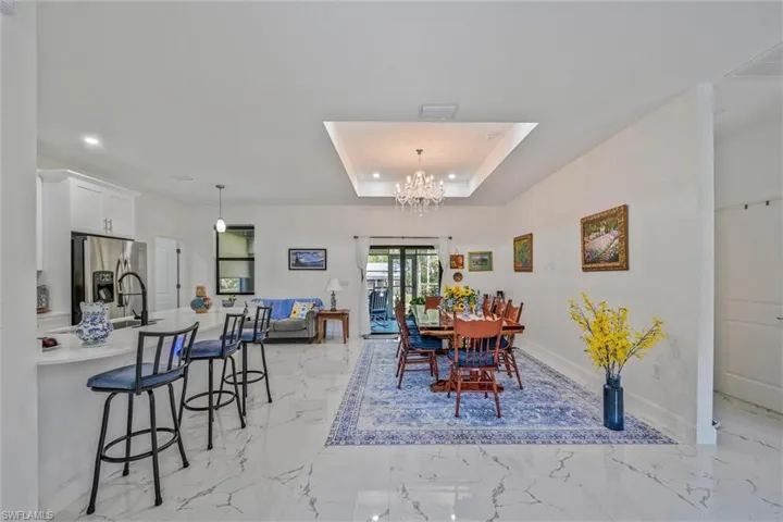 Open-concept living space with large format tile flooring throughout