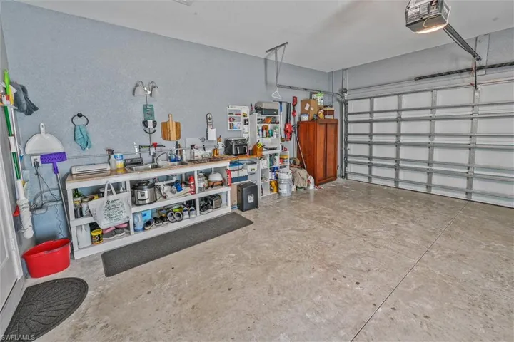 Spacious garage featuring concrete flooring and a white sectional garage door