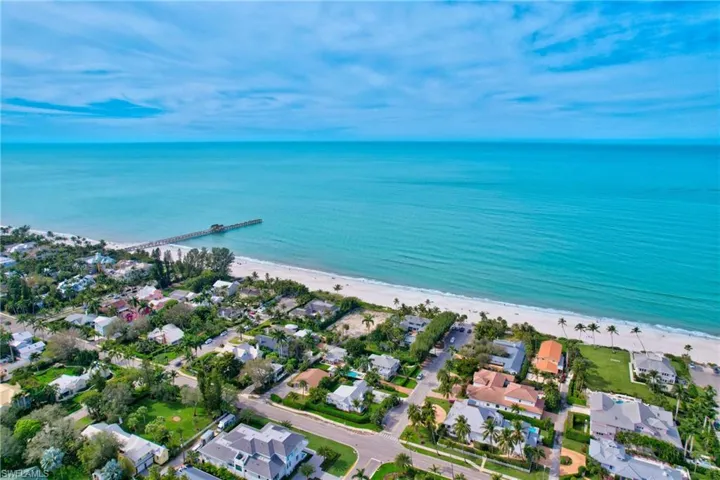 Birds eye view of property featuring a view of the beach and a water view