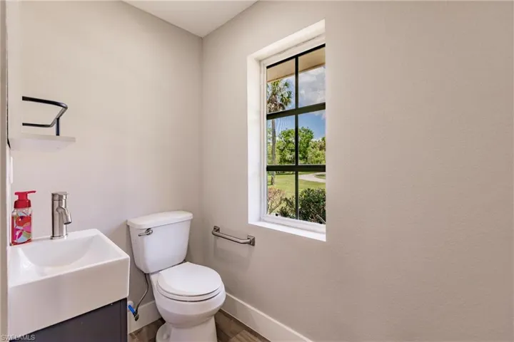 Bathroom with plenty of natural light, vanity, and toilet