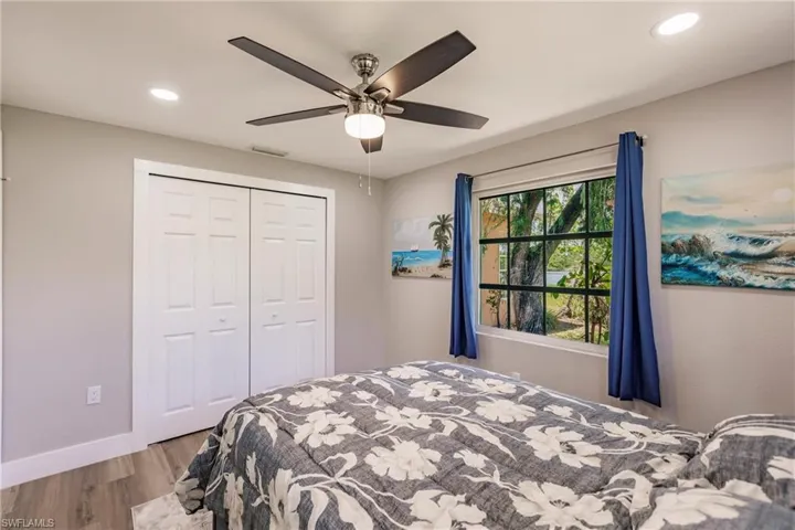 Bedroom with LTV/ wood-style flooring, a closet, and ceiling fan