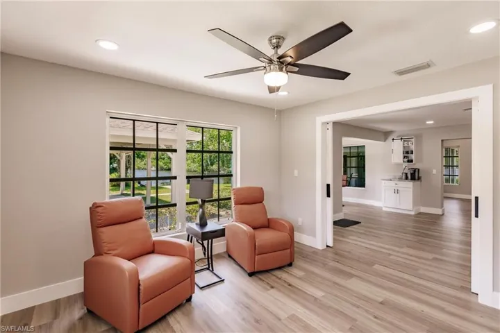 Sitting room with LVT / wood-style flooring and ceiling fan