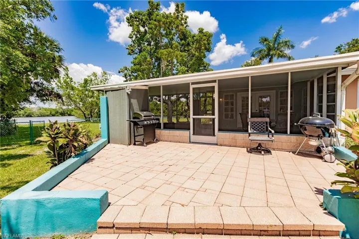 View of patio / terrace featuring a grill and a sunroom