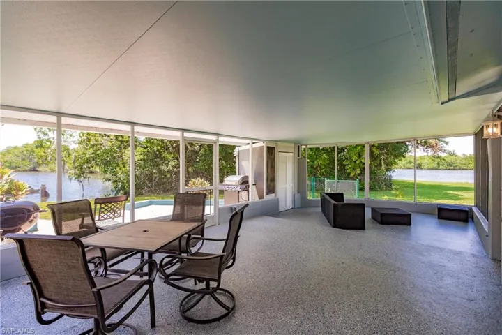 Sunroom / solarium featuring a wealth of natural light and a water view