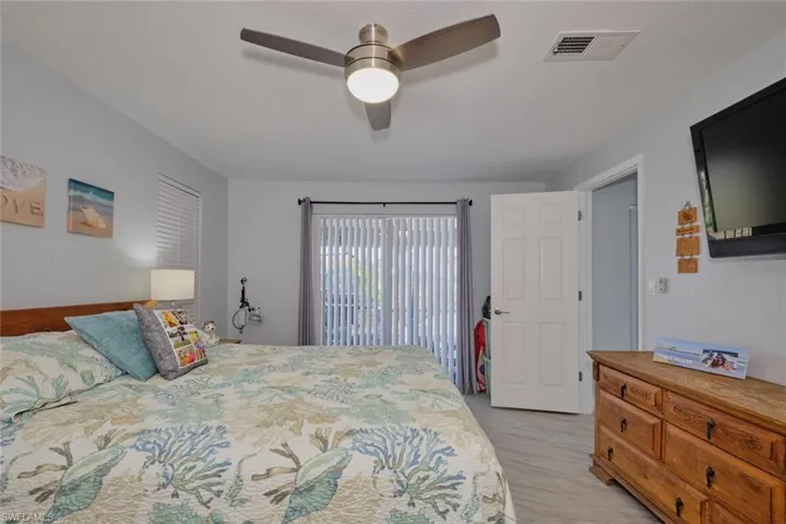 Bedroom with light hardwood / wood-style floors and ceiling fan