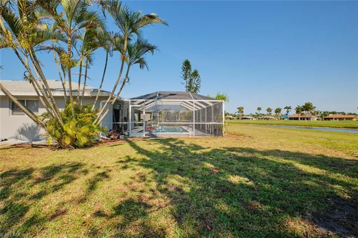 View of yard featuring glass enclosure