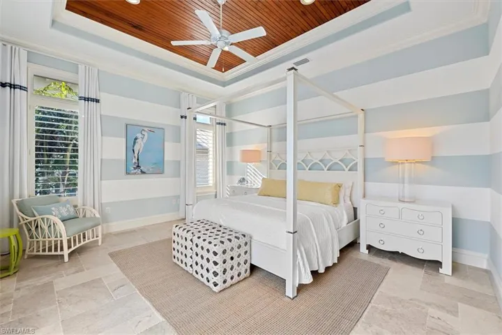 Bedroom with crown molding, wood ceiling, and a raised ceiling