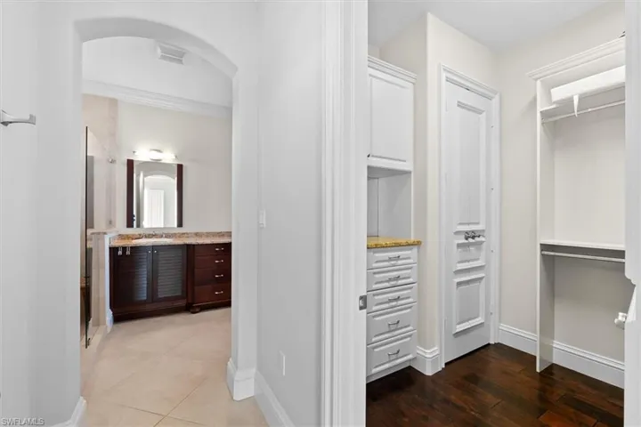 Spacious closet with hardwood / wood-style flooring