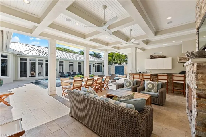 View of patio with outdoor lounge area, ceiling fan, and exterior bar