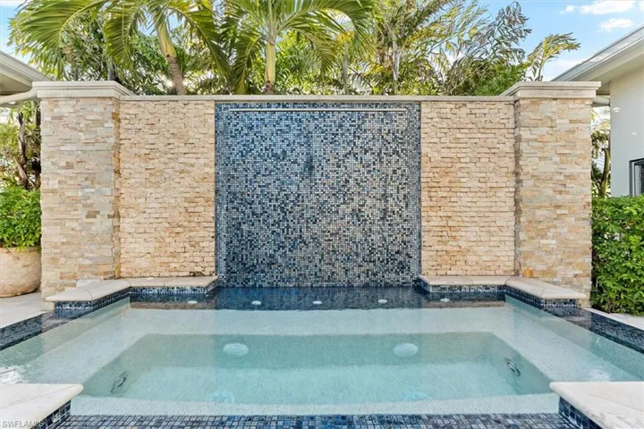 View of pool featuring a hot tub