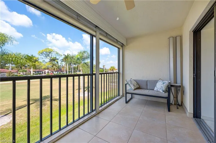 Lanai/Balcony with tile floors, storm shutters,  outdoor dining area and golf course views