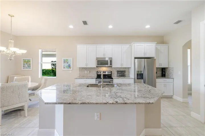 Granite Countertops and Stainless Steel appliances.  Low bar island - Builder Upgrade