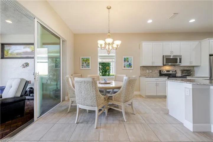 Large eat in kitchen area overlooking pool, spa and lake