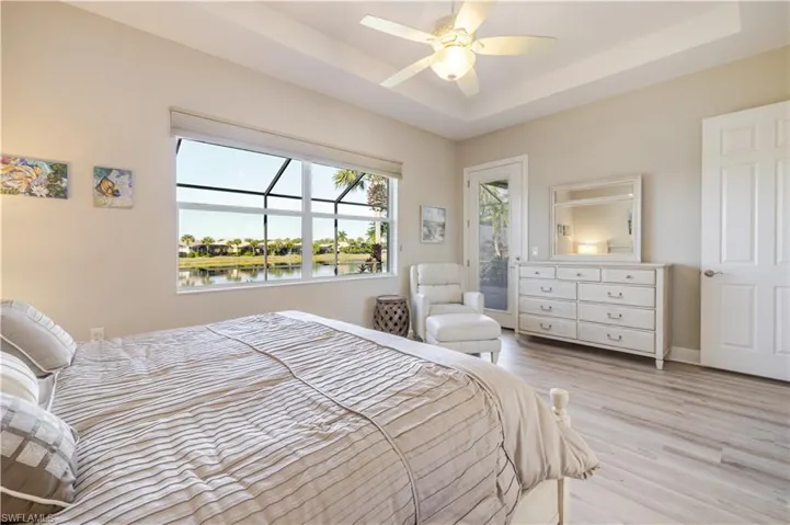 Primary Bedroom with private door to outside lanai pool area (Builder Upgrade)