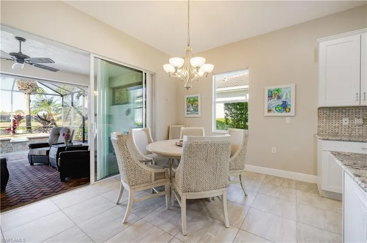 Large eat in kitchen area overlooking pool, spa and lake