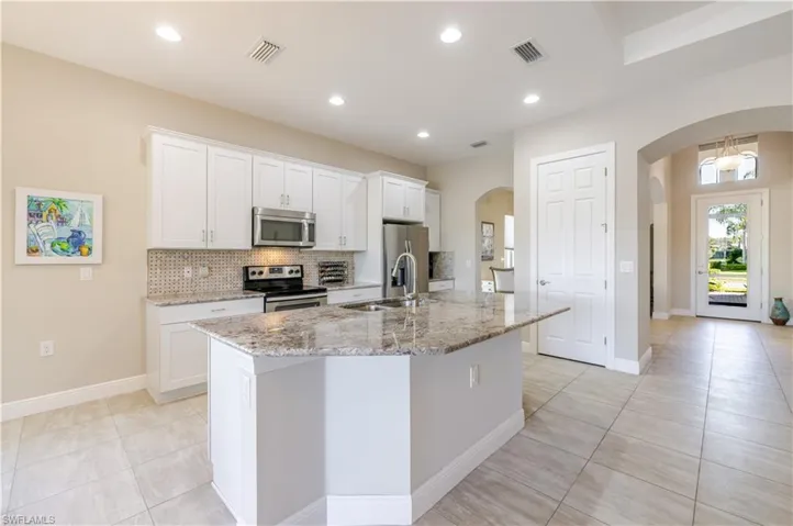 Granite Countertops and Stainless Steel appliances.  Low bar island - Builder Upgrade