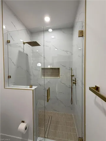Bathroom with a marble finish shower