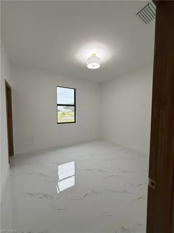 Empty room with light marble finish flooring and baseboards