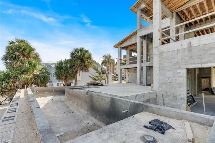 View of swimming pool featuring a balcony and stairs