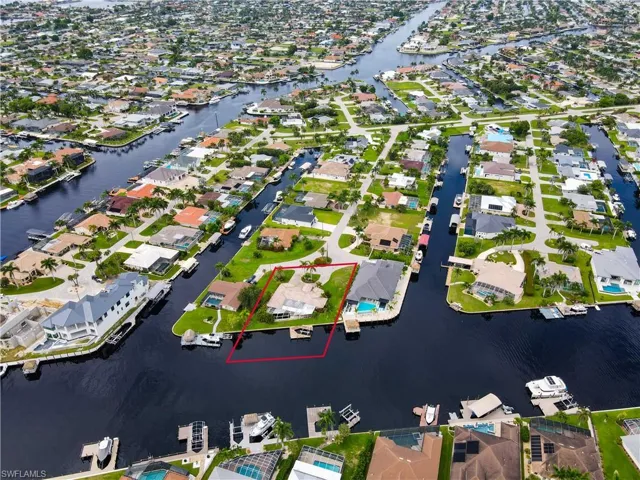 Aerial overview of property's location featuring nearby suburban area and a nearby body of water