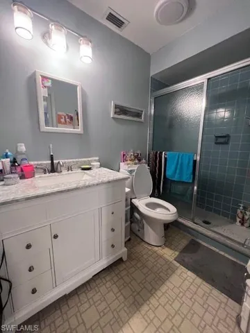 Bathroom featuring vanity and a shower stall
