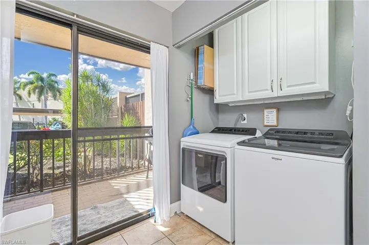 Laundry area featuring cabinet space and washing machine and dryer