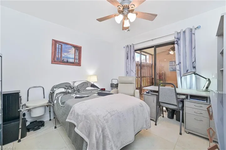 Bedroom with ceiling fan and light tile patterned floors