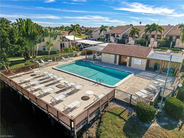 Community pool featuring a patio area, a residential view, and a deck