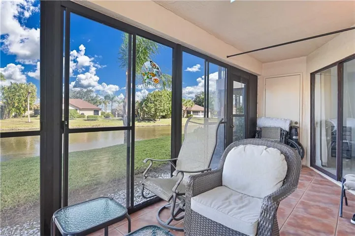 Sunroom / solarium featuring a water view