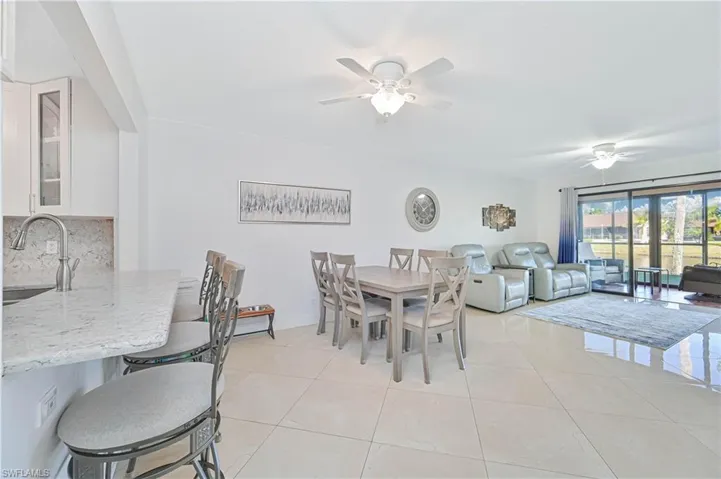 Dining room with a ceiling fan and light tile patterned floors