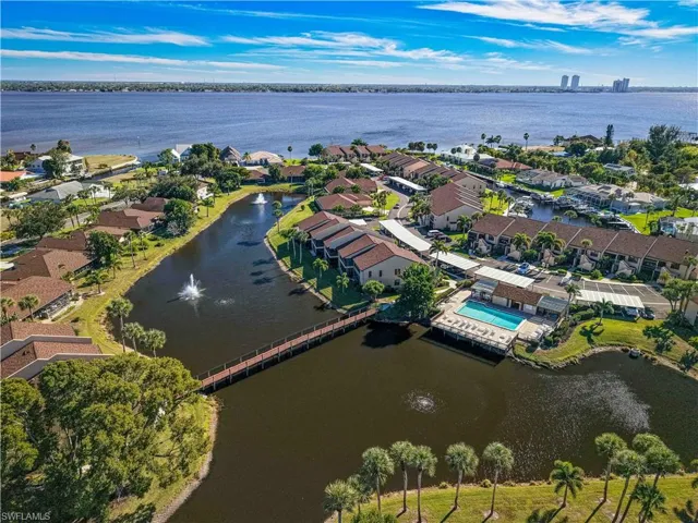 Aerial view of property's location featuring a large body of water and nearby suburban area