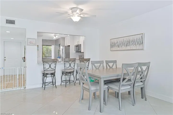 Dining area featuring light tile patterned flooring, a ceiling fan, and recessed lighting