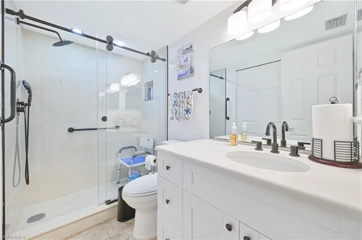 Full bath featuring vanity and a shower stall