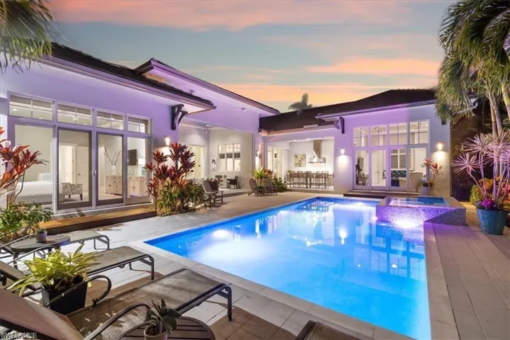 View of swimming pool featuring a patio, french doors, and a pool with connected hot tub
