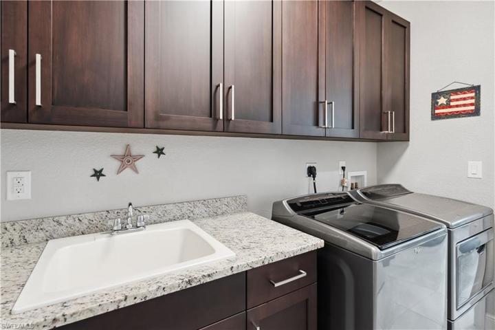 Laundry room with new washer & dryer plus plenty of extra storage cabinetry.